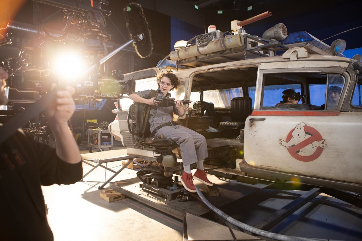 Portions of the chase sequence were shot onstage. Here, actor Mckenna Grace is prepped for a shot, positioned in the Ecto-1’s outrigger seat.
