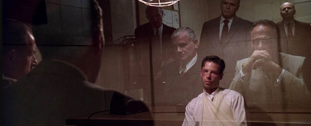 LAPD investigator Ed Exley (Guy Pearce) is grilled by the top brass of L.A.'s municipal government. This scene displays Spinotti's deft use of a one-way mirror to provide a forceful double image of both the inquisitors and the accused.