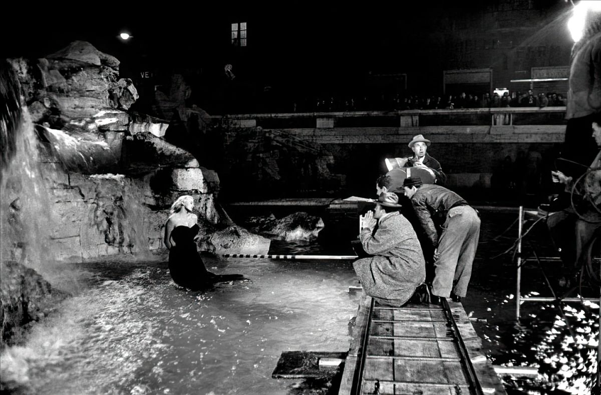 Director Federico Fellini and his crew, including cinematographer Otello Martelli, shooting the famed sequence at the Trevi Fountain in Rome.