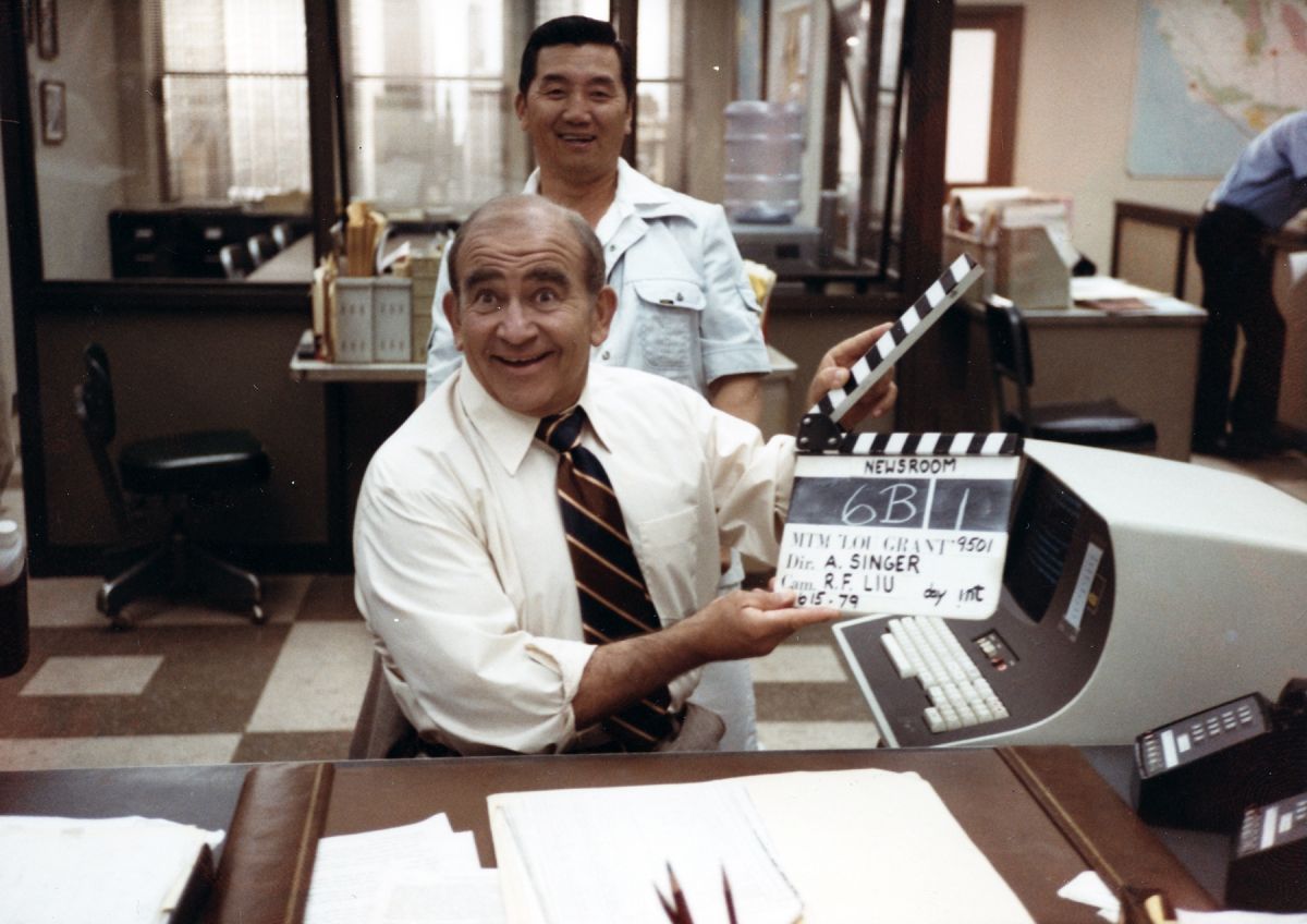 Liu enjoys a light moment with actor Ed Asner on the set of Lou Grant. 