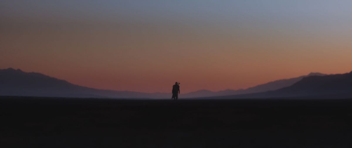  The Mandalorian (aka “Mando,” played by Pedro Pascal) treks through the desert alone. 