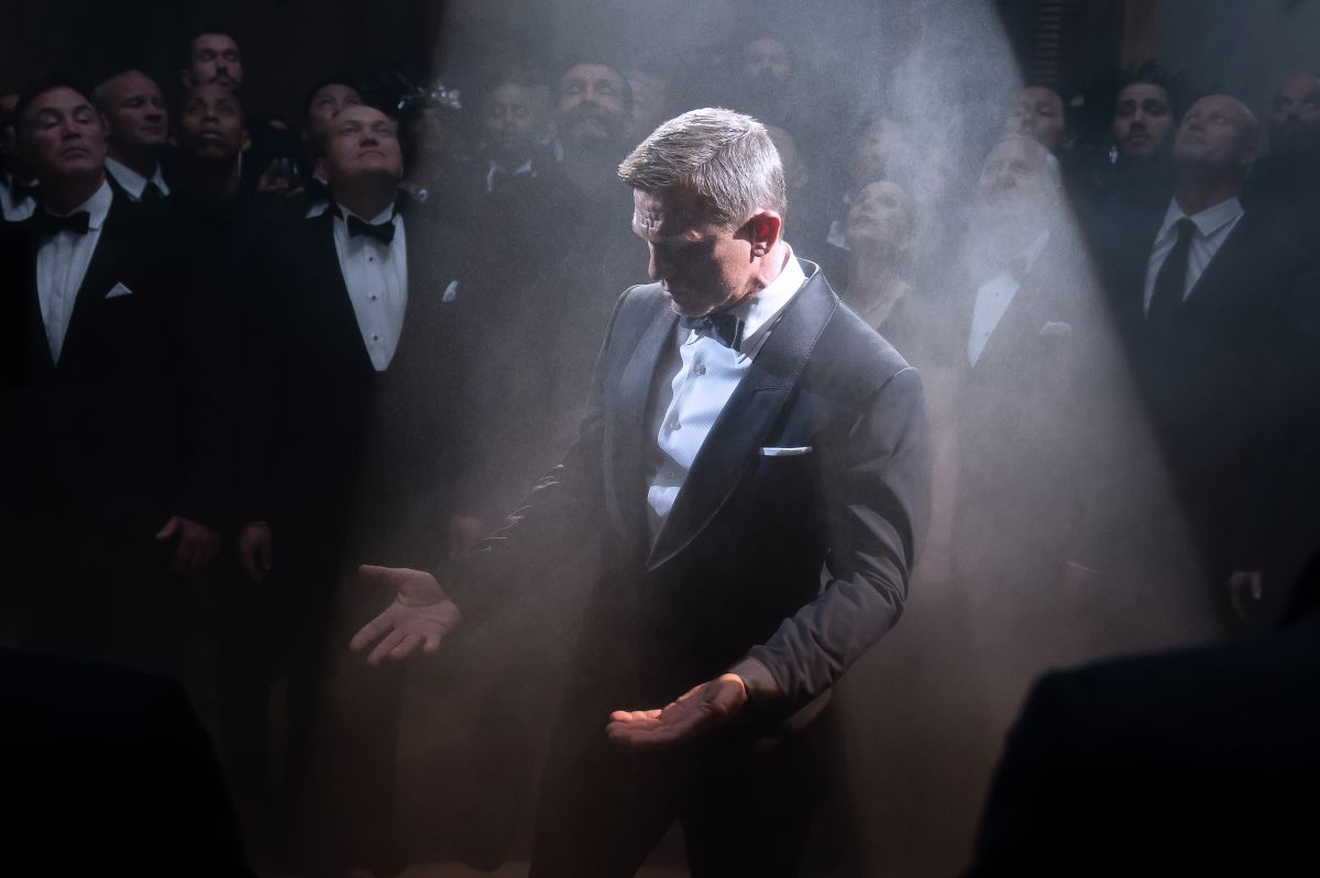 A crisp spotlight shines on Bond at a clandestine Spectre party.