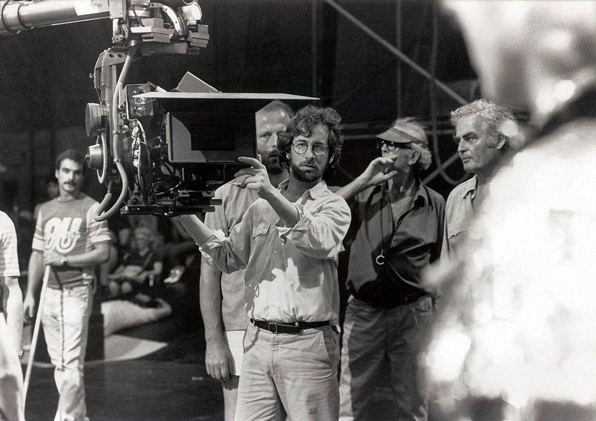 Spielberg with director of photography Douglas Slocombe, BSC (wearing visor) setting up a scene at Club Obi Wan.