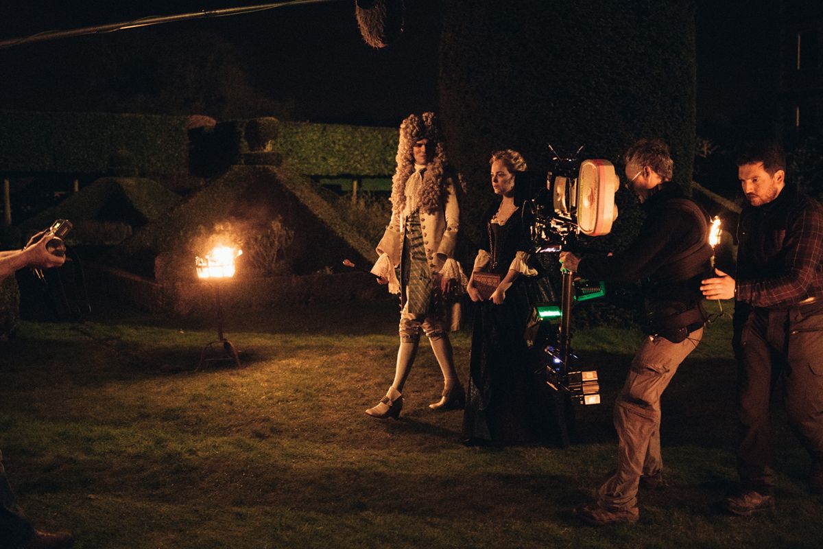 Steadicam operator Paul Edwards keeps pace with Hoult and Stone while filming a night exterior.