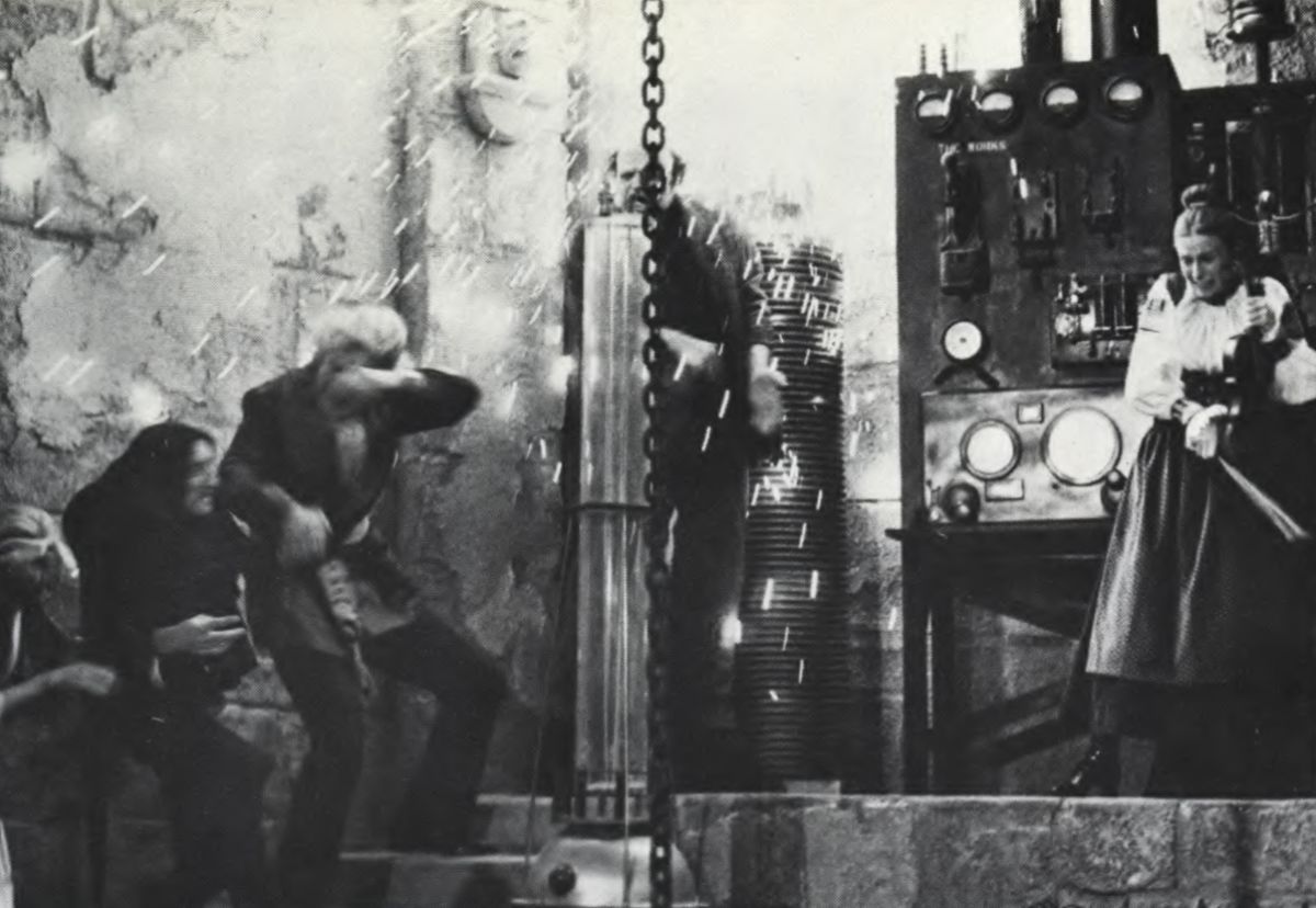 Half hidden by the shower of flame and sparks, the Monster (Peter Boyle), center, climaxes an emotional moment of the story by inadvertently hitting a switch with his flailing arms, almost destroying the old laboratory. 